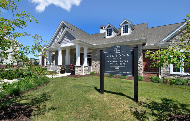 a large house with a sign in front of it