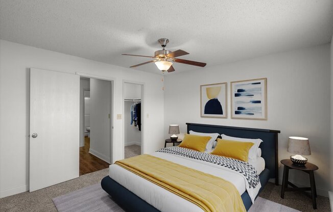 a bedroom with a bed and a ceiling fan