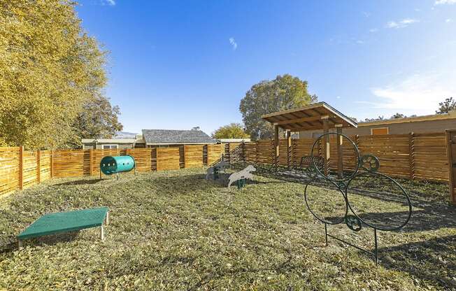 Large grassy dog run area with fence and tunnels at Park View Apartments, Wenatchee Washington