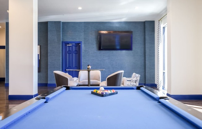 social area with billiards at Reveal on the Lake apartments