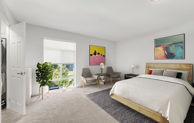 A bedroom with a large bed and a painting on the wall.