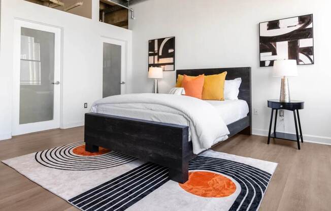a bedroom with a bed and a rug