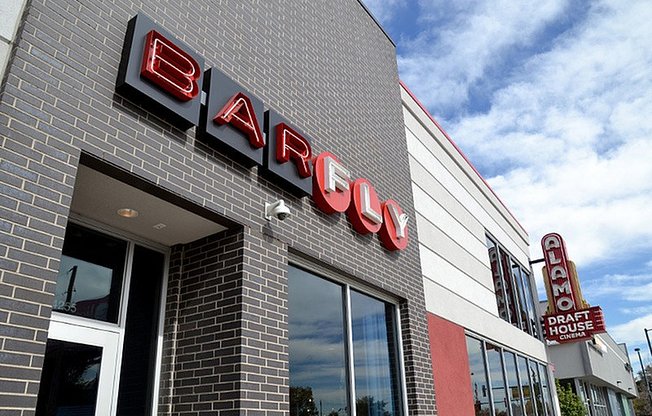 Experience the vibrant atmosphere at BarFly, located adjacent to Alamo Drafthouse Cinema.