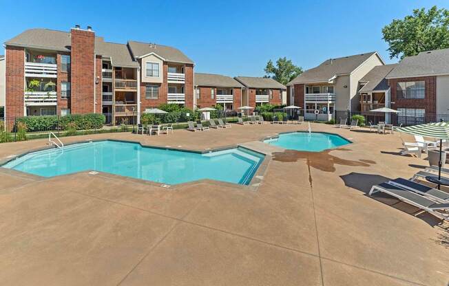 A large swimming pool surrounded by apartment buildings.