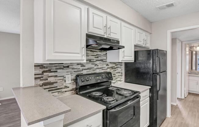 a stove top oven sitting inside of a kitchen