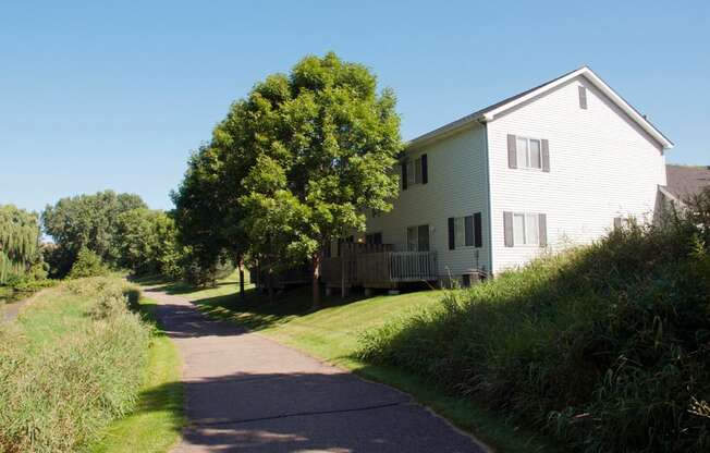 paved outdoor walking path going past a house