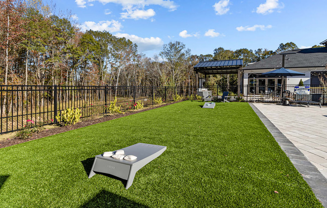 A backyard with a lawn and a grill.