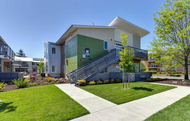 Apartment Exterior with Walking Path, Grass, Stairs and Trees