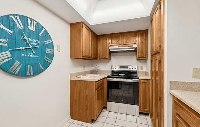 A kitchen with a large clock on the wall at Hampton Apartments, Florida, 33759