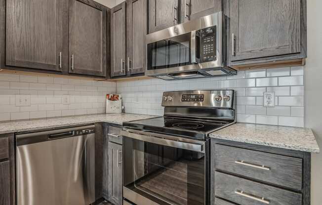 Kitchen with Dark Brown Cabinetry and Stainless Steel Appliances