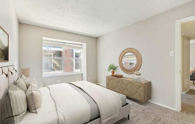 a bedroom with a bed and a dresser and a window