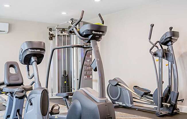 A row of Sportaer exercise bikes are lined up in a row.