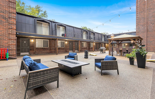 a patio with furniture and a fire pit