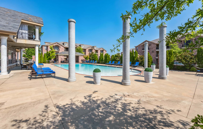 our apartments offer a swimming pool with lounge chairs and trees