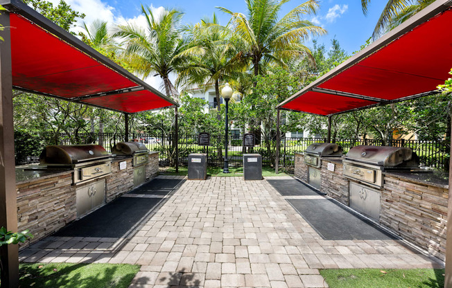 a picnic area with barbecue grills and a red roof
