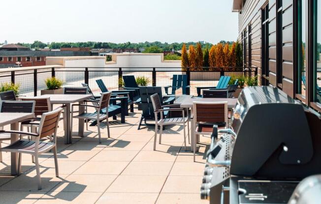 a patio with tables and chairs on the roof of a building at Barrington 101, Barrington, IL 60010