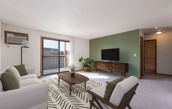 Mandan, ND Garden Grove Apartments. A living room with green walls and a sliding glass door to a balcony