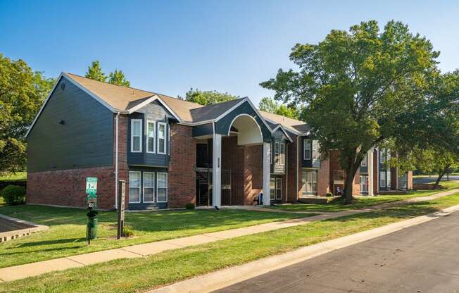 Exterior Of Apartment Homes At Willowbend Surrounded With Lush Grass