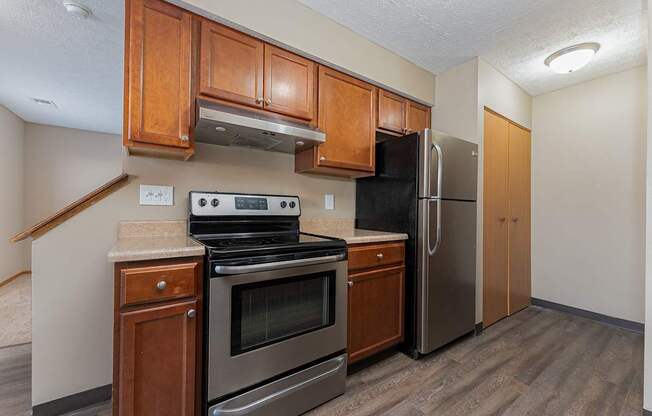A kitchen with a stove, oven, and refrigerator.