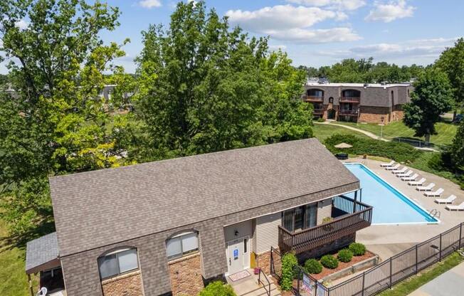 an aerial view of a clubhouse with a pool