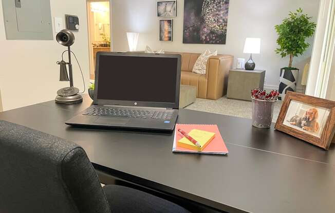 a laptop computer sitting on a desk in a living room