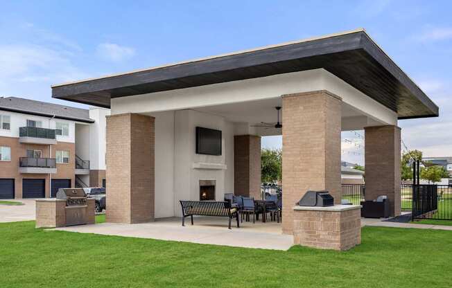A covered patio area with a table and chairs.