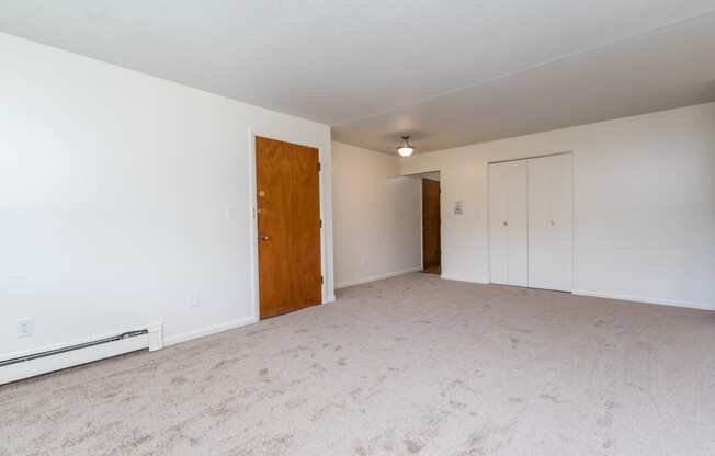 a bedroom with a carpeted floor and white walls