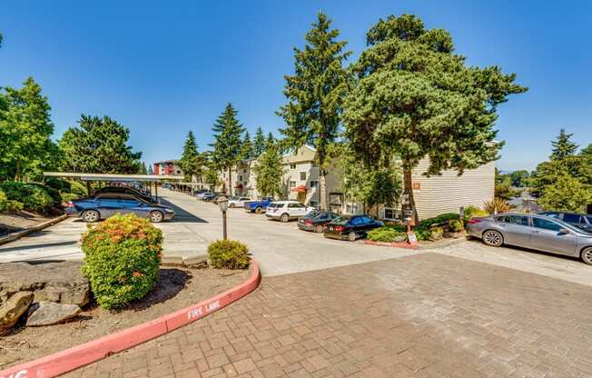 a parking lot with cars parked in front of a building