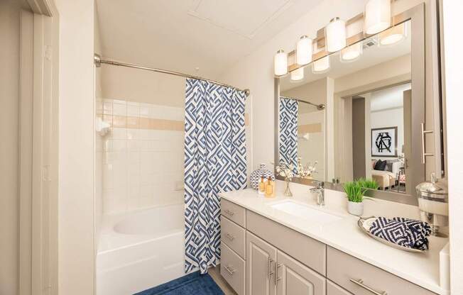 Bathroom with a white tub at Woodbridge Villas Apartments, Sachse, TX