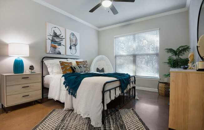 a bedroom with a bed and a ceiling fan