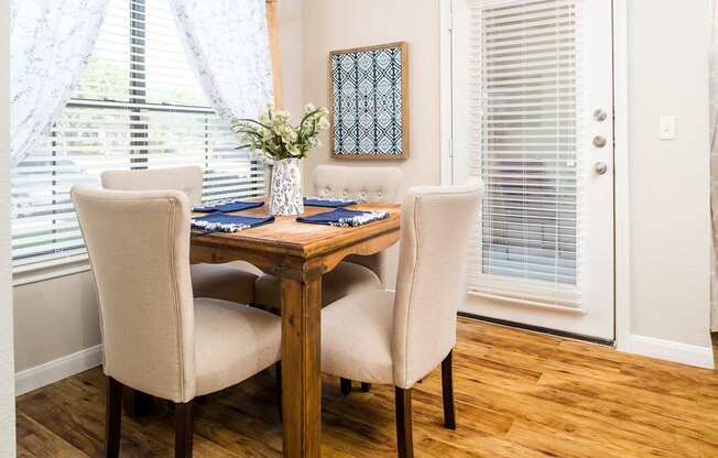 A dining room with a wooden table and chairs.