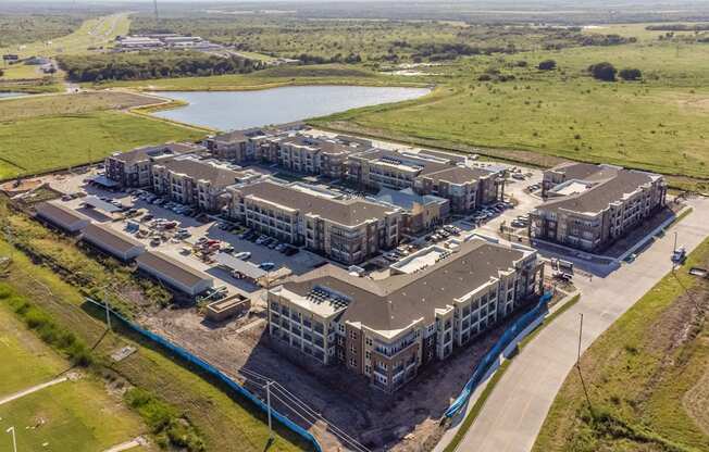 an aerial view of a group of buildings and a lake