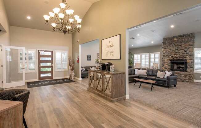 A foyer with a stone fireplace and a large painting on the wall at Zinfandel Village Apartments, California, 95670