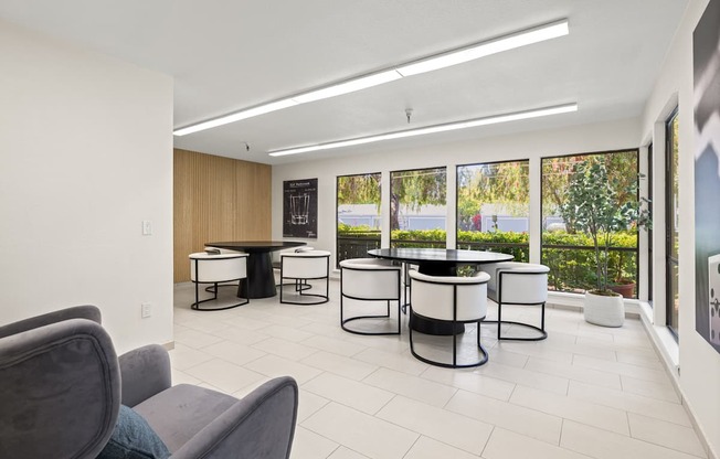 A modern living room with a grey sofa and a glass table.