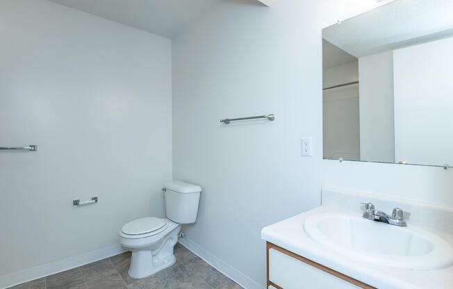 a room with a sink and a mirror