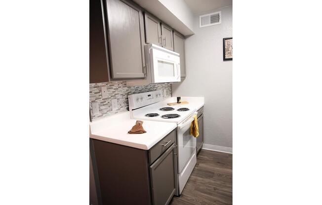 a kitchen with a stove and a refrigerator