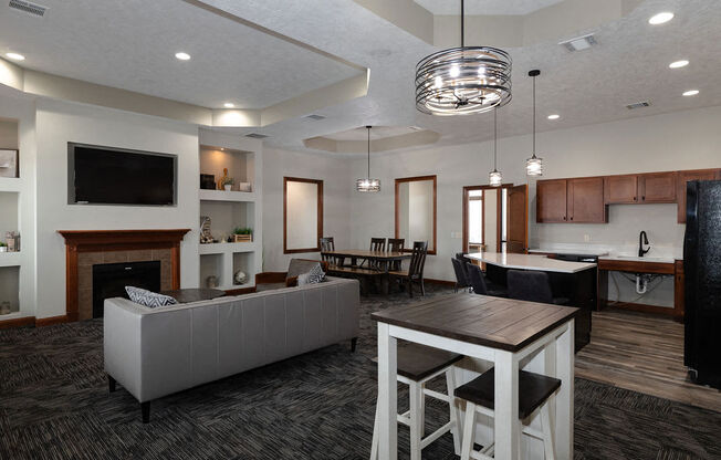 a living room and kitchen with a table and chairs