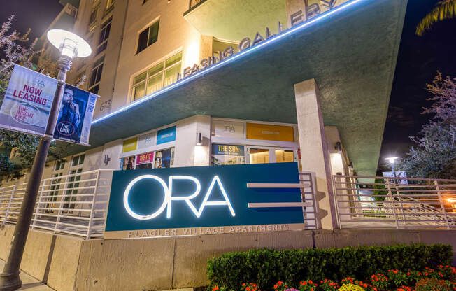 the facade of the ora building at night