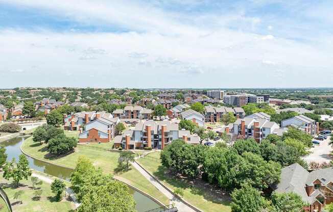 Aerial view of Heritage at Valley Ranch with pond, walking paths, and surrounding Irving neighborhood.