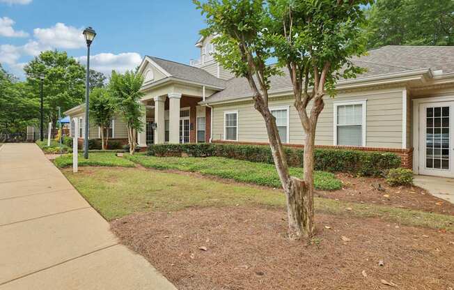 A tree in front of a house.