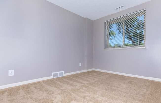 carpeted bedroom with window  at 444 Park Apartments, Richmond Heights, Ohio