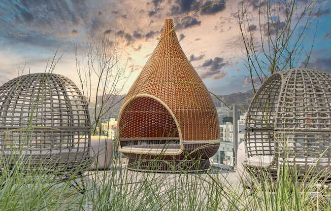 a building with a pointed roof made out of wicker