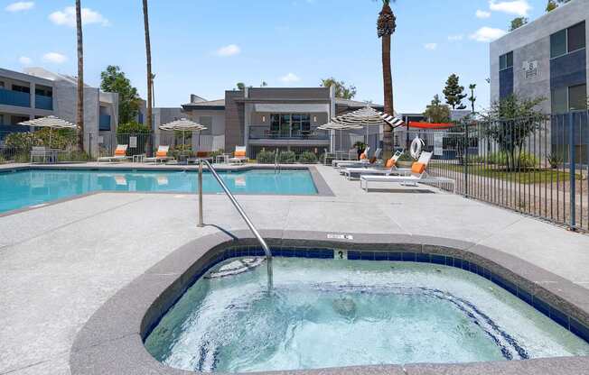 A hot tub sits in the middle of a pool surrounded by chairs.