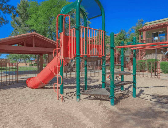 Outdoor Playground equipped with a slide, monkey bars, and latter