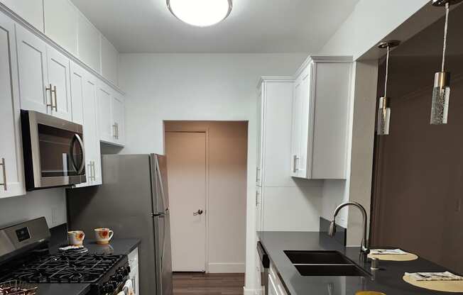 Renovated kitchen with quartz countertops and shaker door design