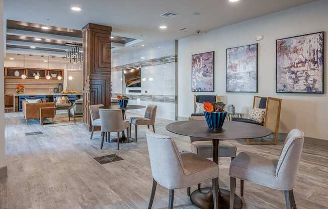 A modern dining room with a round table and chairs.