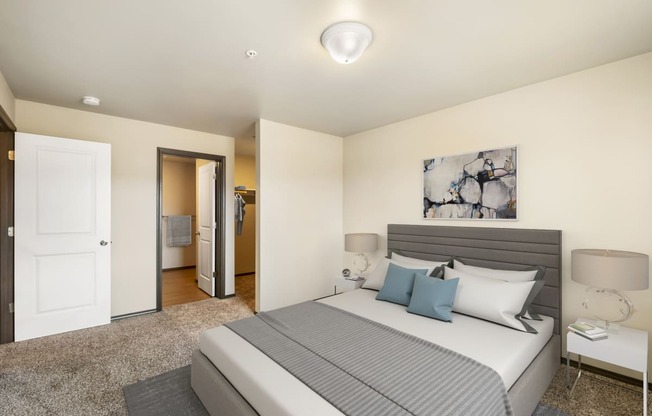 a bedroom with a large bed and a door to a bathroom  at Altitude, East Wenatchee, Washington