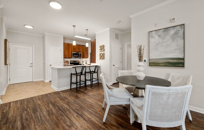 a dining room and kitchen with a table and chairs