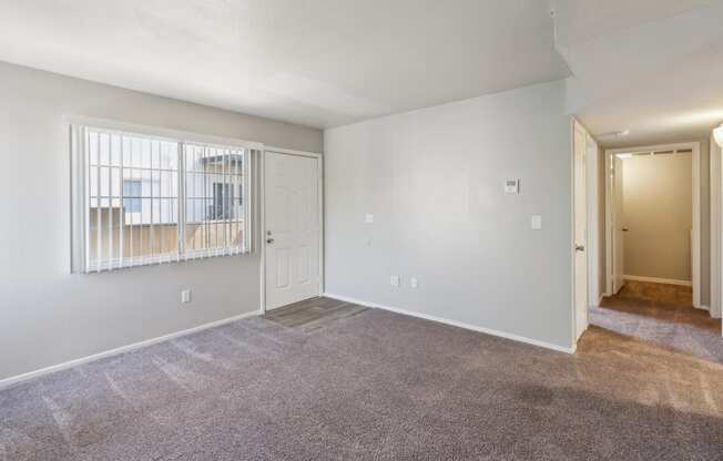 the living room of an empty apartment with white walls