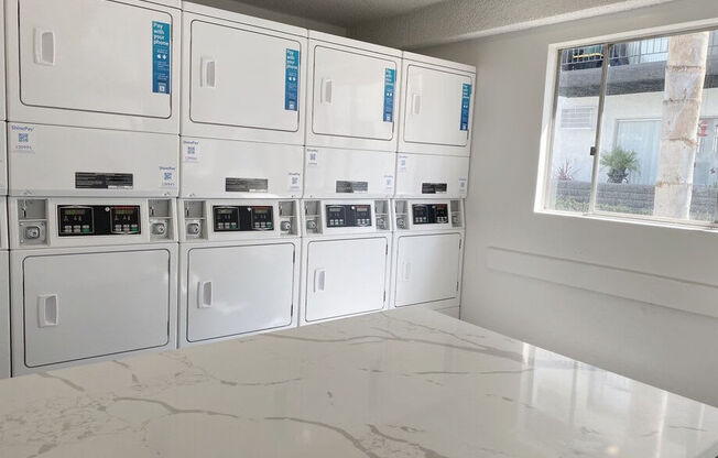 a bunch of white appliances in a room at Latitude Apartments at Mission Valley, San Diego